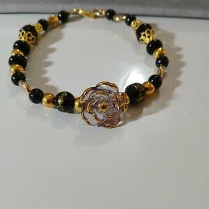NWT Handcrafted Black and Gold Trimmed Glass Flower Beaded Bracelet.